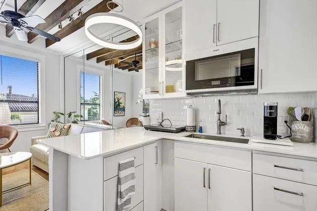 a kitchen with a sink a stove and cabinets
