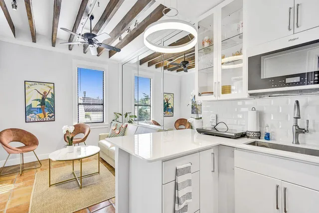 a kitchen with a sink cabinets and window