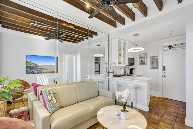 a living room with furniture and a chandelier