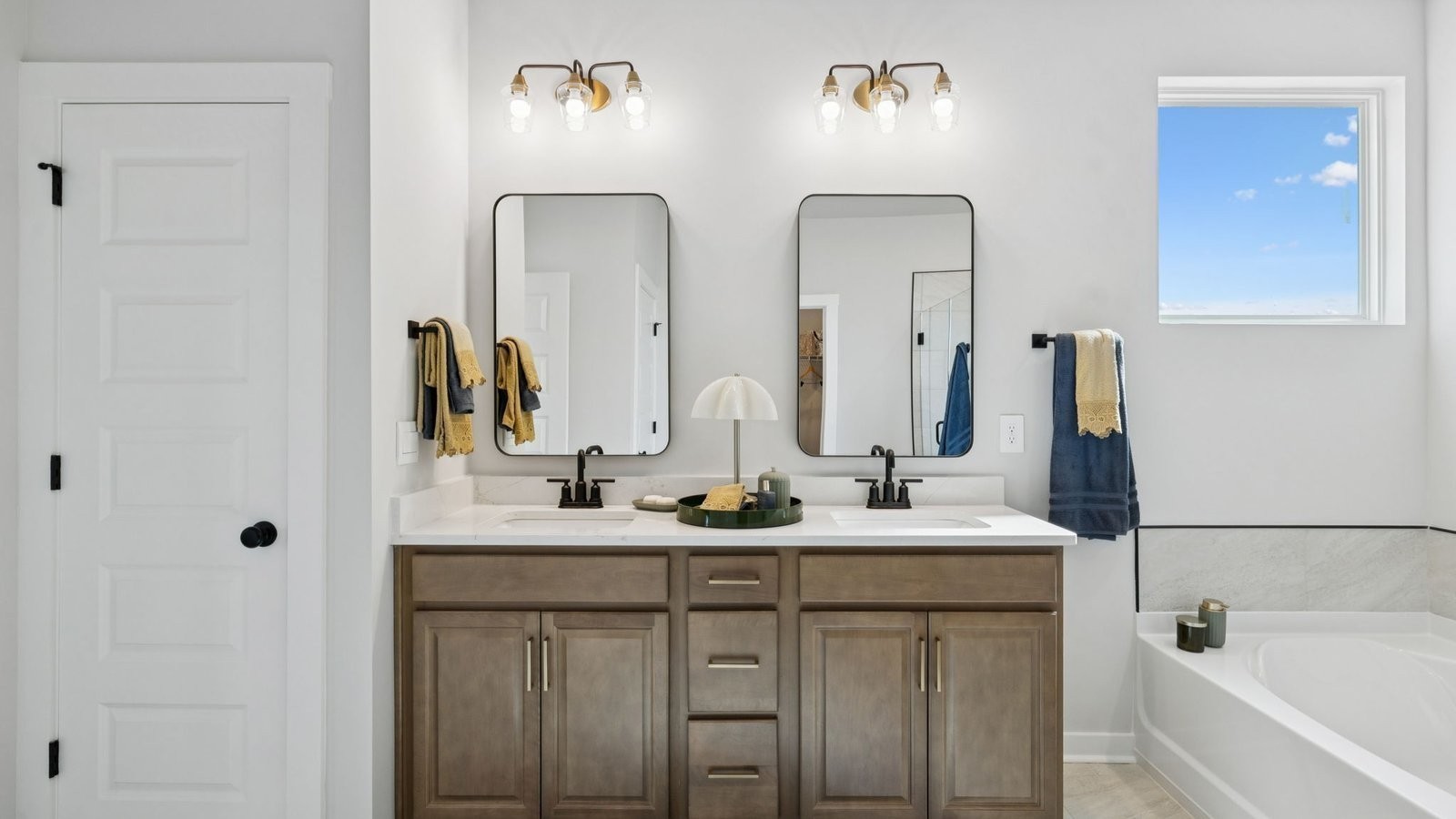 306 Harvest Point Boulevard Spring Hill, TN 37174 - Photo 33 of 70 a bathroom with double vanity sinks and a mirror