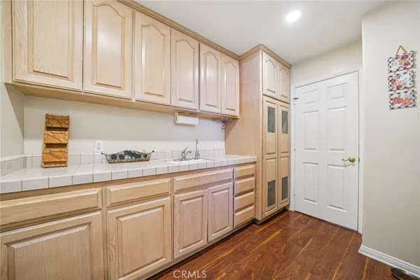 a kitchen with stainless steel appliances granite countertop a refrigerator and white cabinets