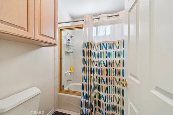 a bedroom with furniture and a flat screen tv