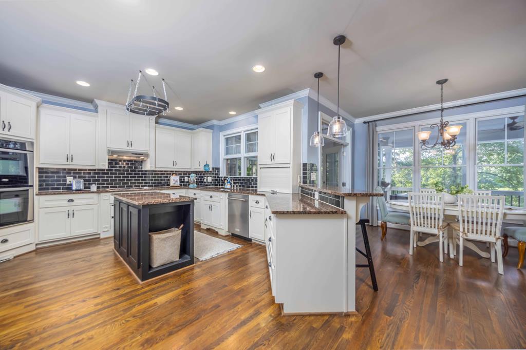 178 Rolling Farm Way Midland, GA 31820 - Photo 16 of 65 a kitchen with a table chairs refrigerator and cabinets
