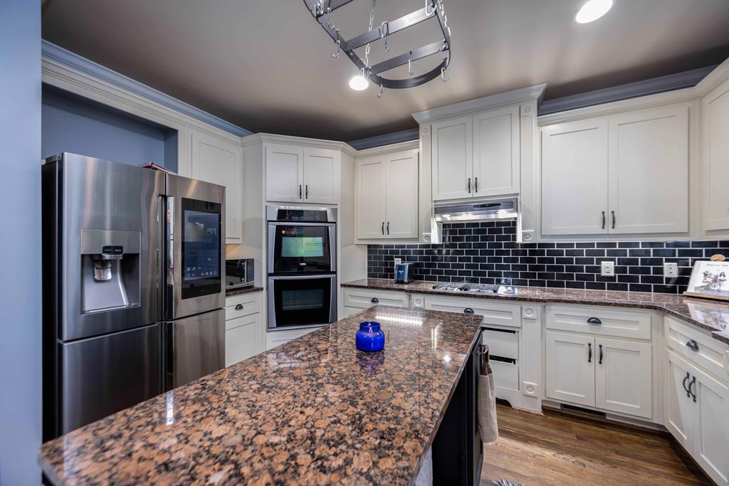 178 Rolling Farm Way Midland, GA 31820 - Photo 18 of 65 a kitchen with stainless steel appliances granite countertop a sink refrigerator and cabinets