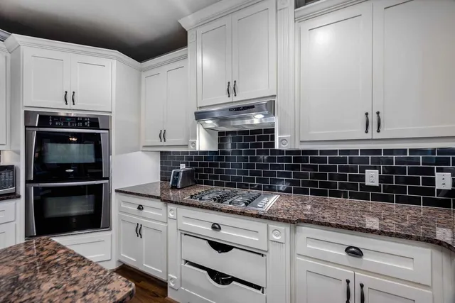 a living room with furniture and floor to ceiling windows