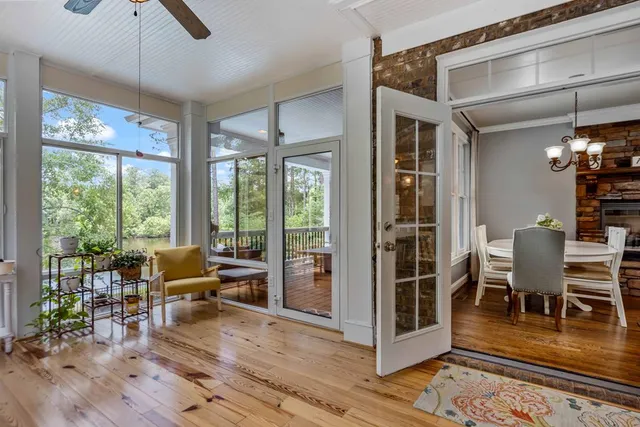 a living room with furniture and large windows