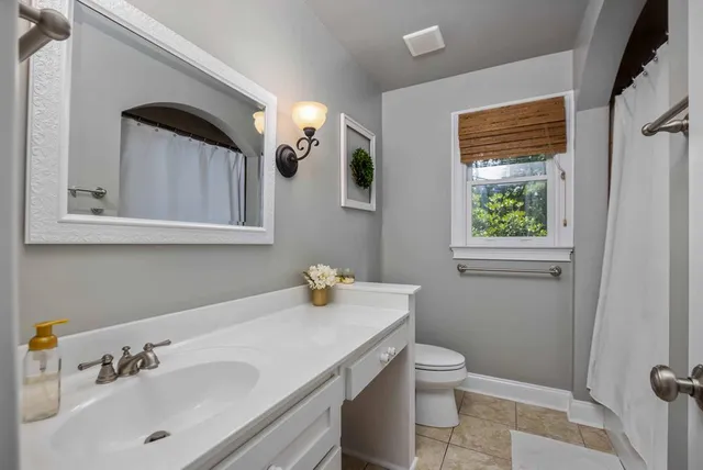 a bedroom with a large bed and a flat tv screen