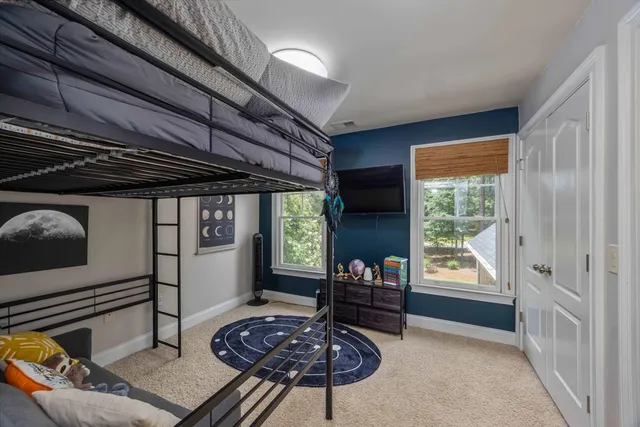 a spacious bathroom with a granite countertop sink a toilet a mirror and bathtub