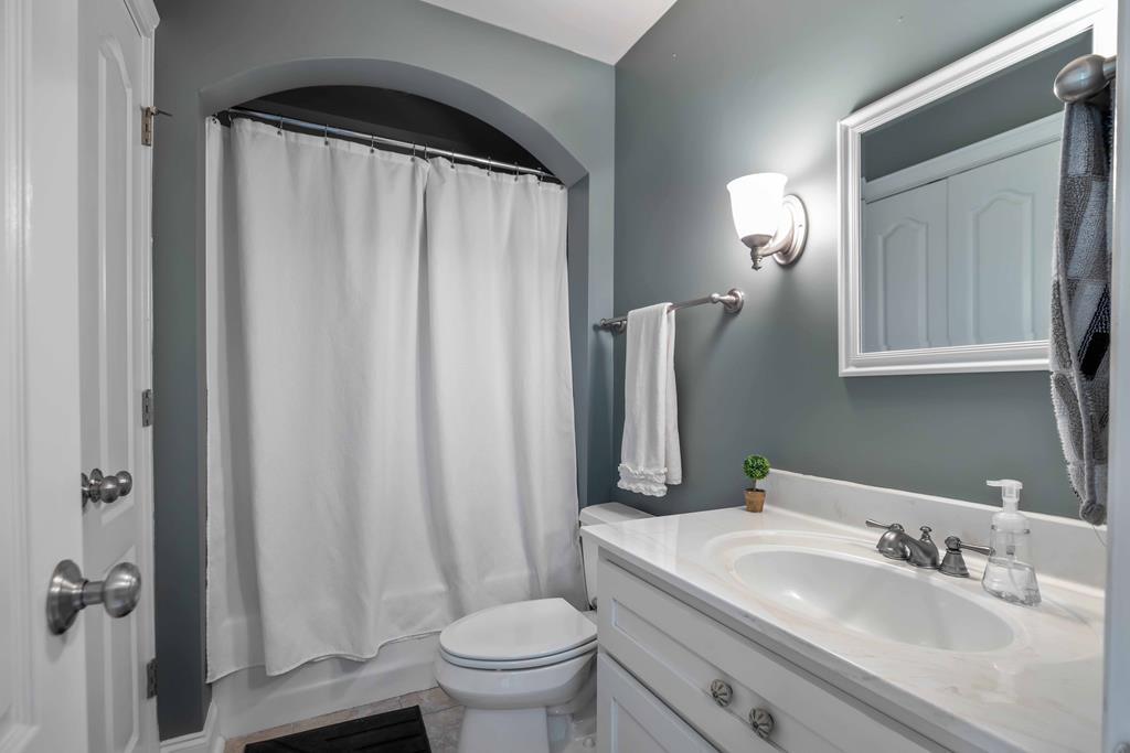 178 Rolling Farm Way Midland, GA 31820 - Photo 34 of 65 a bathroom with a sink a toilet and a mirror