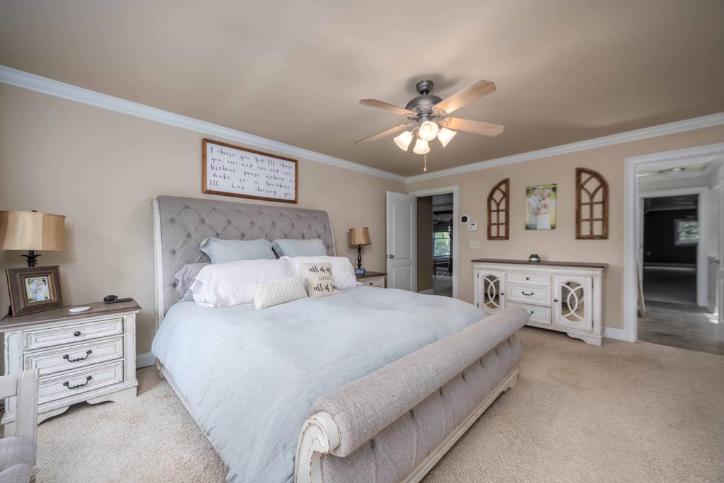 178 Rolling Farm Way Midland, GA 31820 - Photo 35 of 65 a bedroom with a bed and a chandelier
