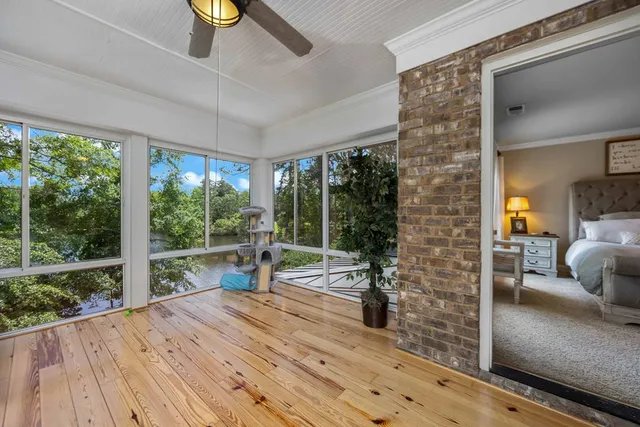 a living room with furniture a flat screen tv and a dining table