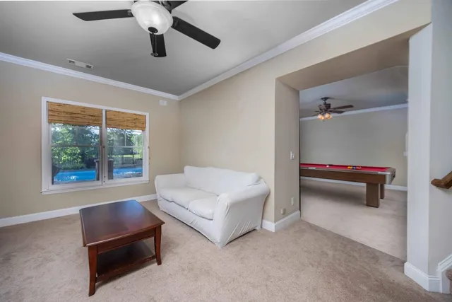 a view of a house with backyard and sitting area