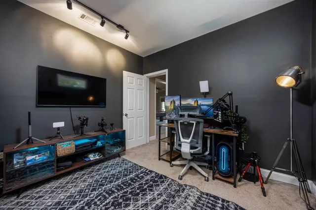 an aerial view of a house with outdoor space and a garden
