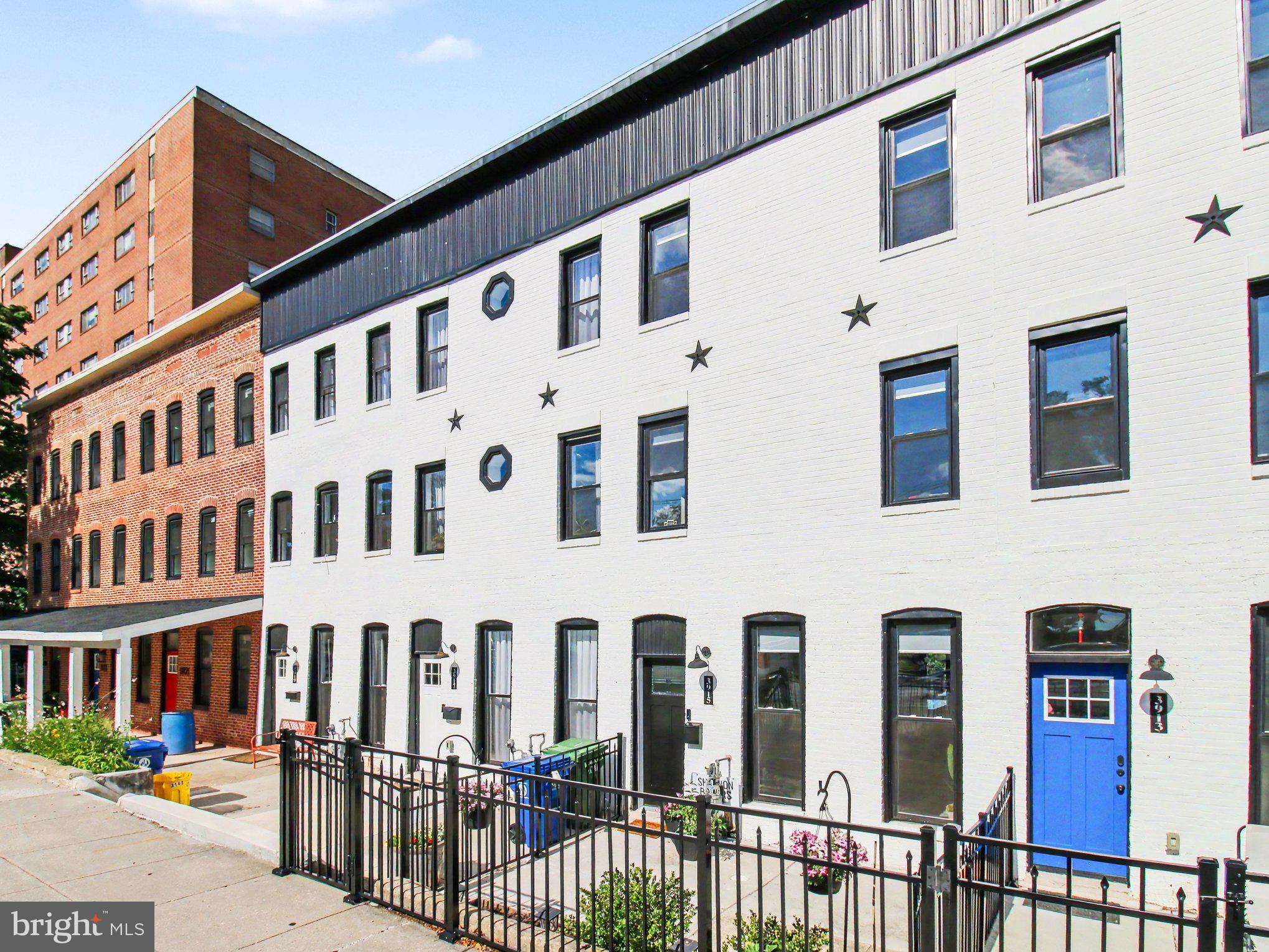 3915 Roland Avenue Baltimore, MD 21211 - Photo 6 of 26 a front view of a building with a street