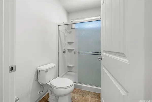 a bathroom with a toilet and a shower