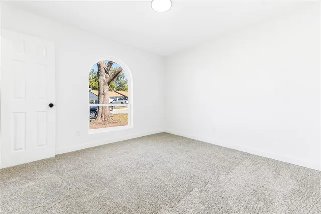 an empty room with windows and entrance