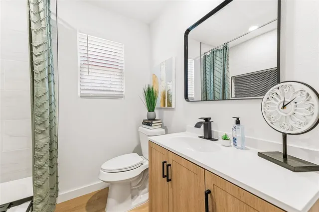 a bathroom with a toilet a sink and a mirror