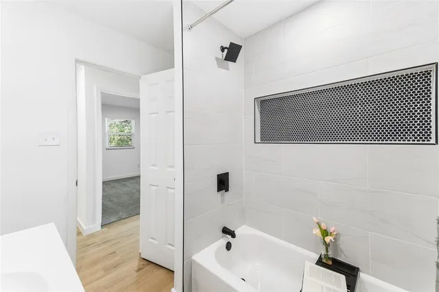 a bathroom with a tub and a sink