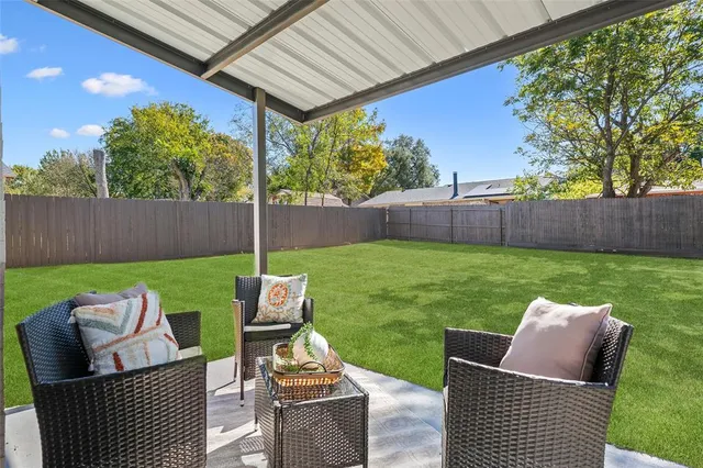 a view of a patio with couches chairs and a yard