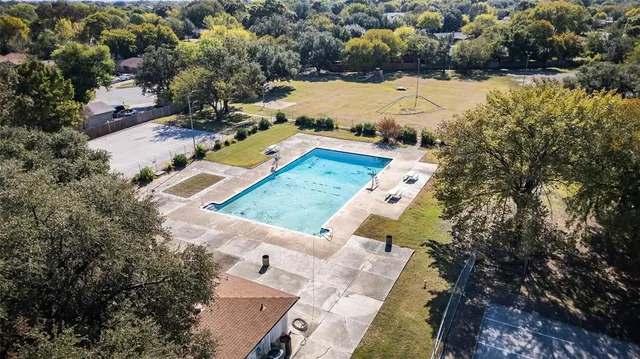 an aerial view of a house with a yard and lake view