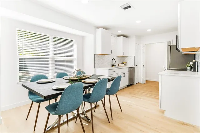 a view of a dining room with furniture and a large window