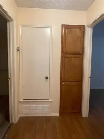 a view of a refrigerator in kitchen and a wooden floor