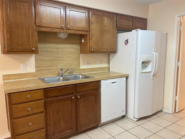 a white refrigerator freezer sitting inside of a kitchen