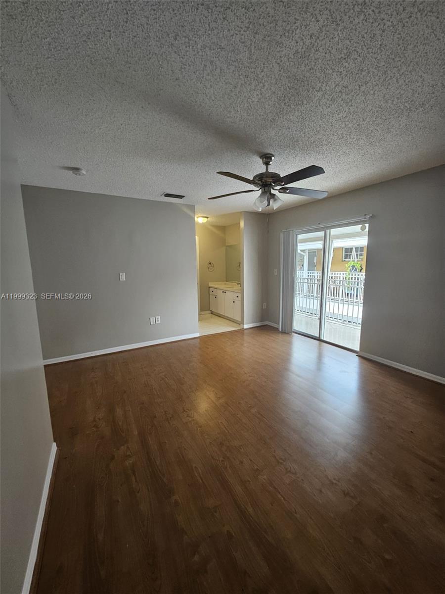 2527 West 76th Street, Unit 208 Hialeah, FL 33016 - Photo 11 of 24 a view of a livingroom with a ceiling fan and window