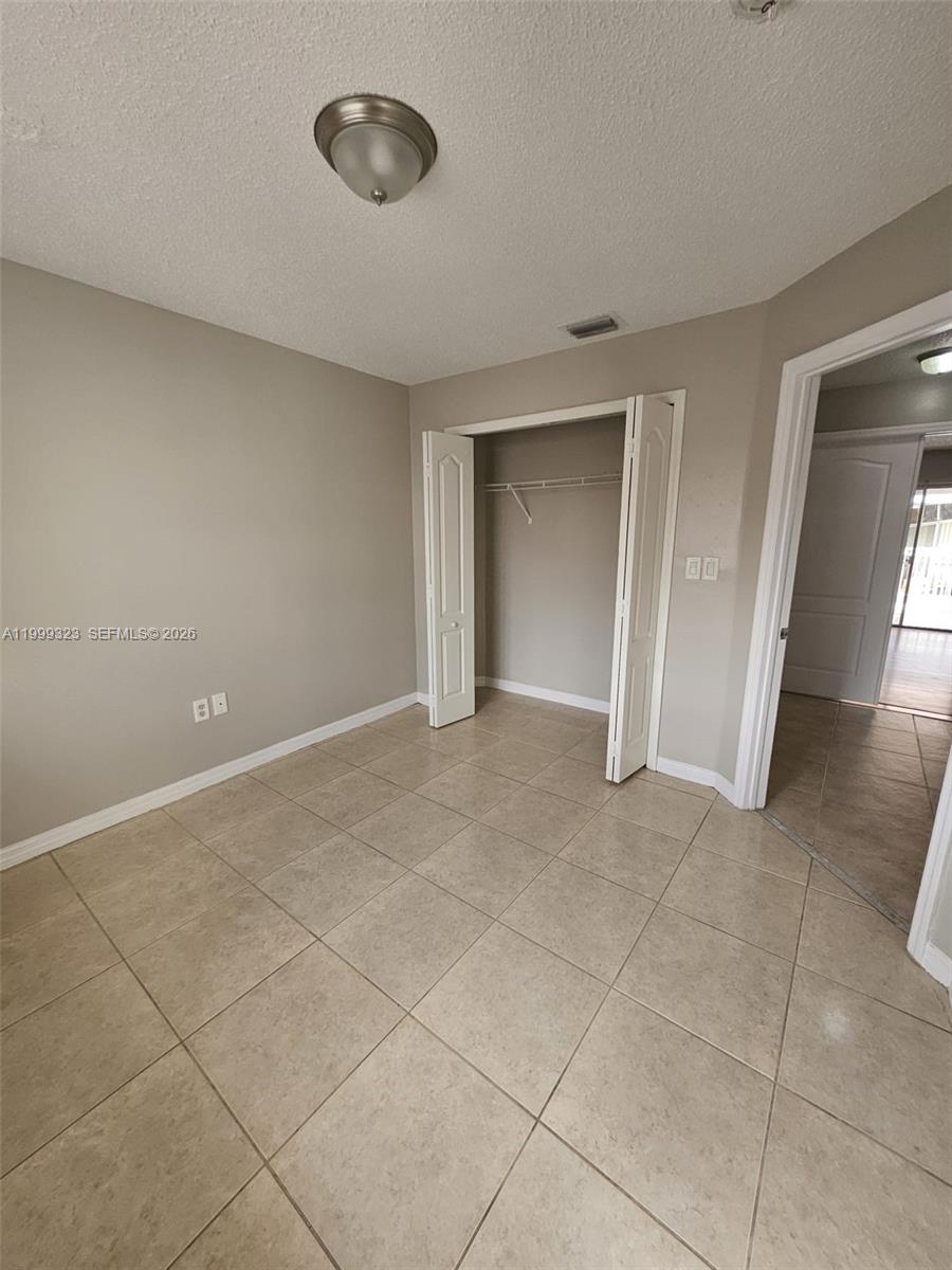 2527 West 76th Street, Unit 208 Hialeah, FL 33016 - Photo 16 of 24 a view of an empty room with a window
