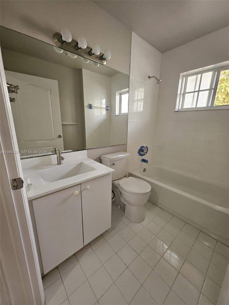 2527 West 76th Street, Unit 208 Hialeah, FL 33016 - Photo 21 of 24 a spacious bathroom with a double vanity sink mirror and toilet