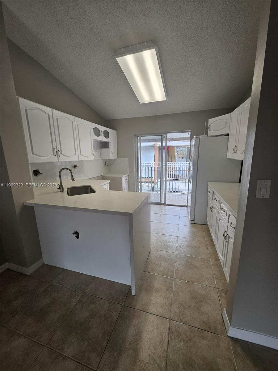 2527 West 76th Street, Unit 208 Hialeah, FL 33016 - Photo 4 of 24 a kitchen with stainless steel appliances granite countertop a sink stove and cabinets