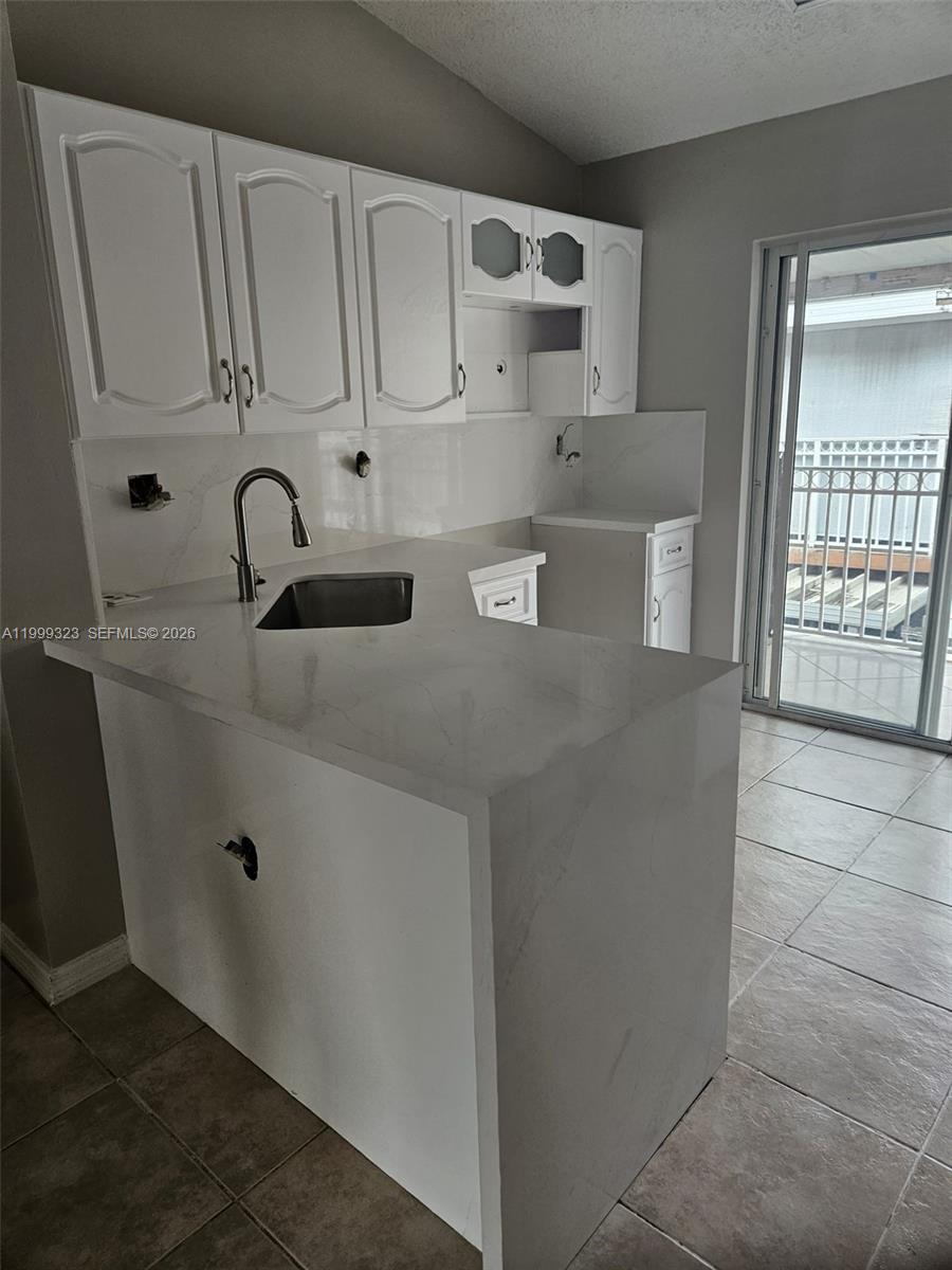 2527 West 76th Street, Unit 208 Hialeah, FL 33016 - Photo 5 of 24 a view of cabinets and window