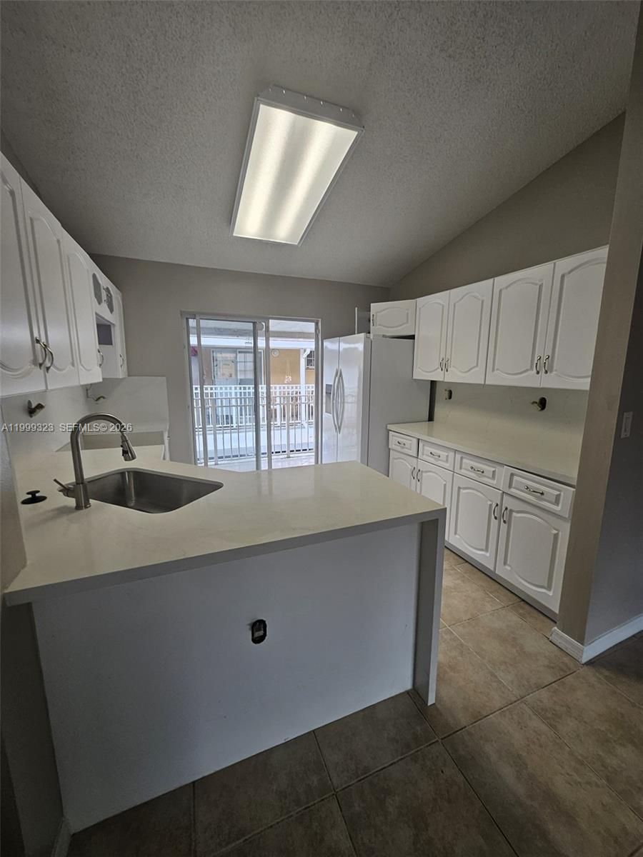 2527 West 76th Street, Unit 208 Hialeah, FL 33016 - Photo 6 of 24 a kitchen with stainless steel appliances a sink stove and cabinets