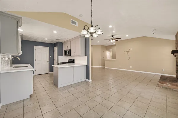 a view of a kitchen with cabinet and a stove top oven