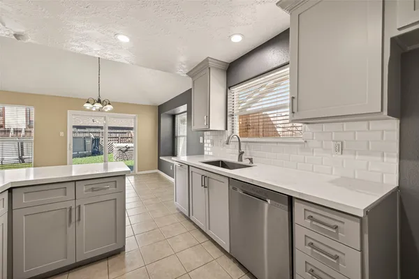 a kitchen with a sink stove and cabinets