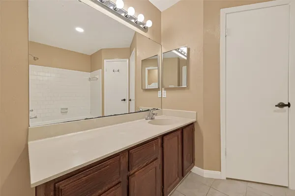 a bathroom with a double vanity sink and a mirror