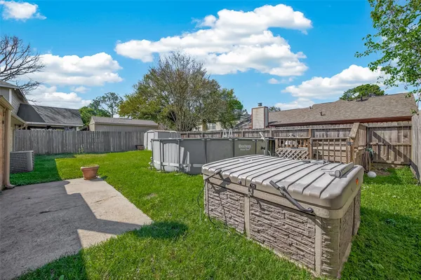 a view of a house with backyard and a garden