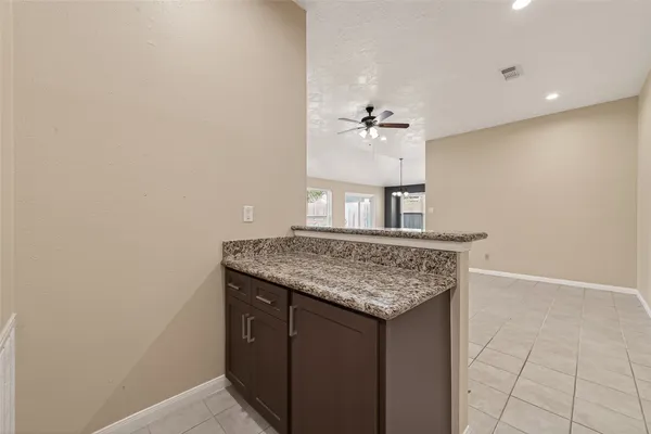 a kitchen with a sink vanity and a chandelier