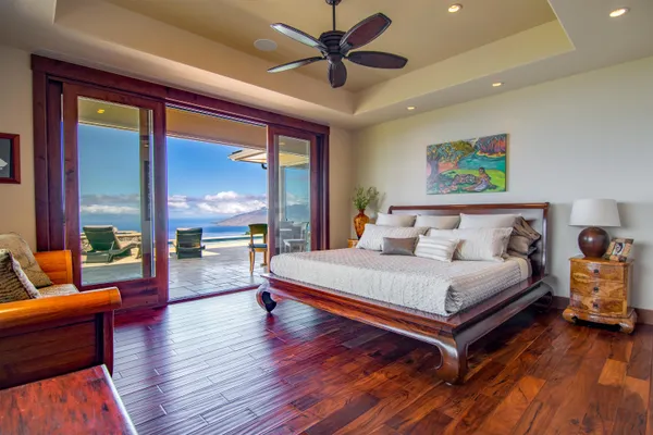 a large bedroom with furniture and a large window