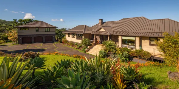 a front view of a house with a yard and balcony