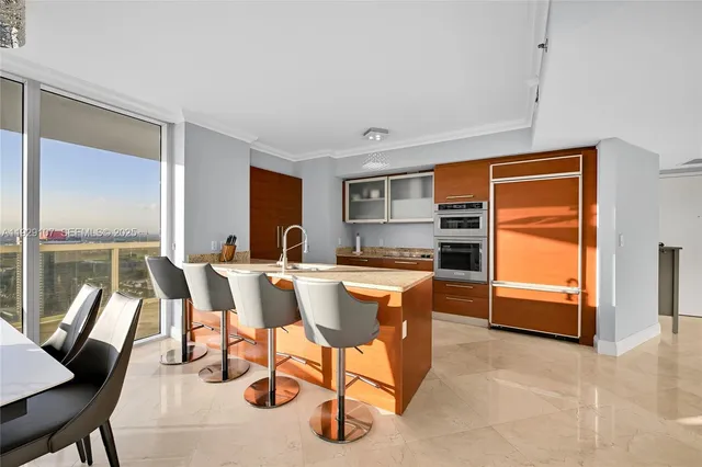 a dining room with furniture and a kitchen view