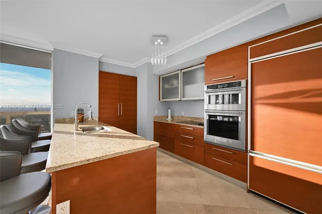 a kitchen with stainless steel appliances granite countertop a sink and cabinets