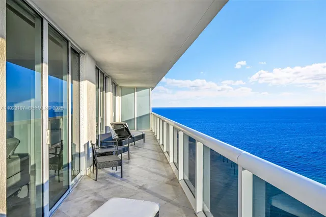 a balcony with chairs and with an outdoor space