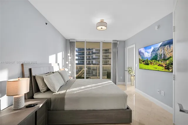 a bedroom with a bed and a flat screen tv