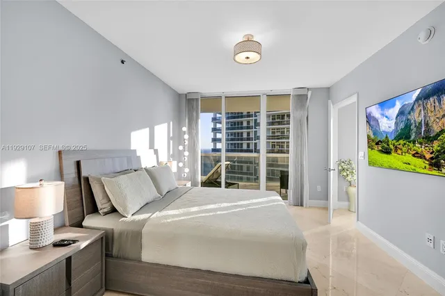 a bedroom with a bed and a large window