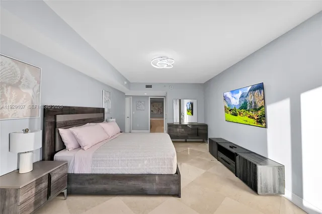 a bedroom with a bed and a couch