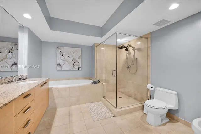 a bathroom with a granite countertop toilet sink and shower