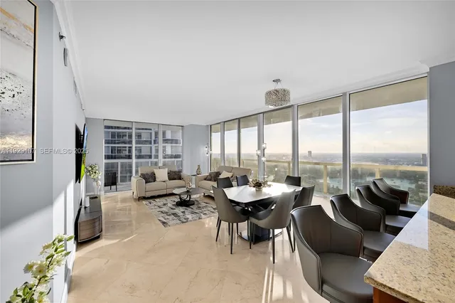 a living room with furniture and large windows