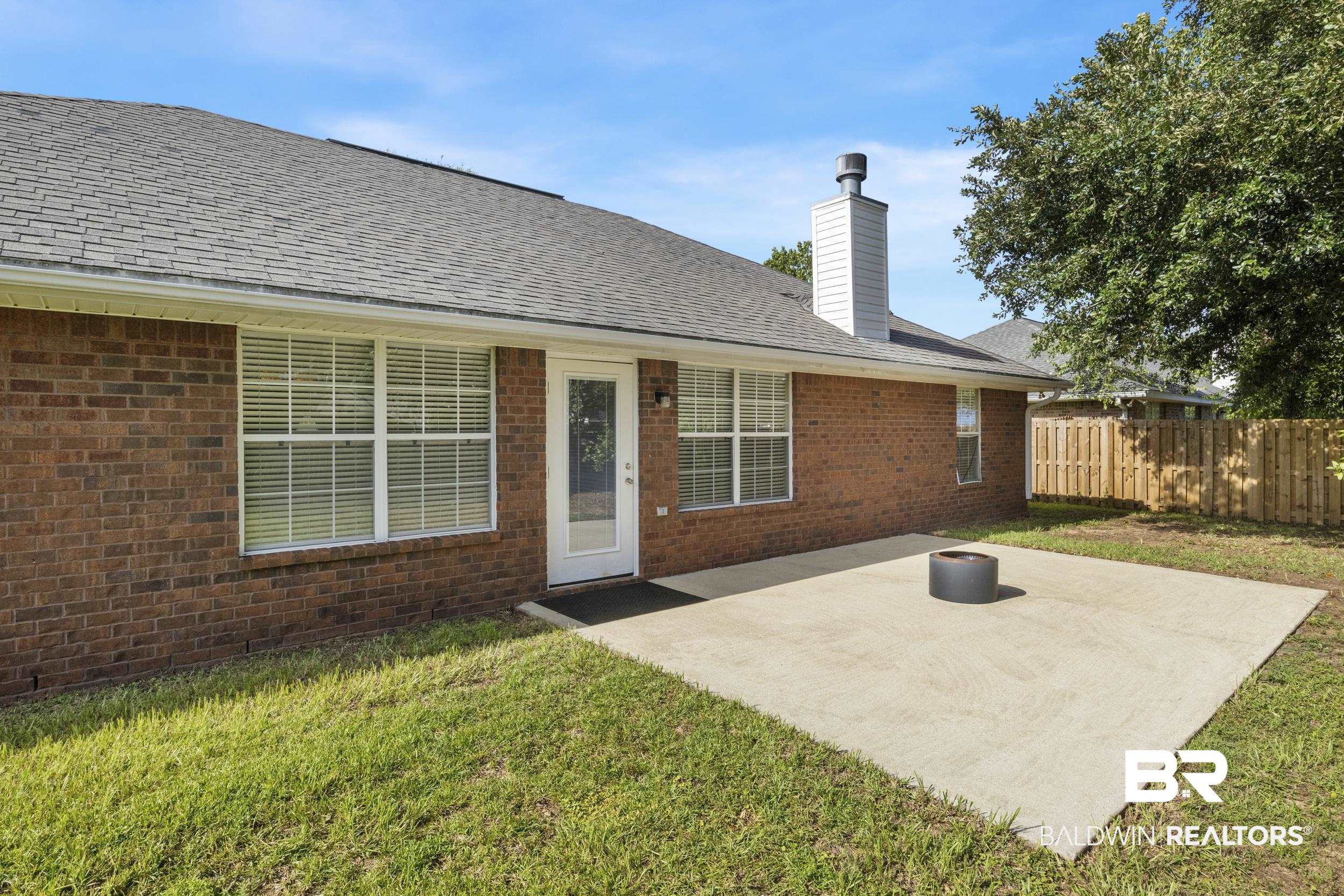 9610 Watkins Drive Fairhope, AL 36532 - Photo 20 of 26 Back of house with a yard and a patio area