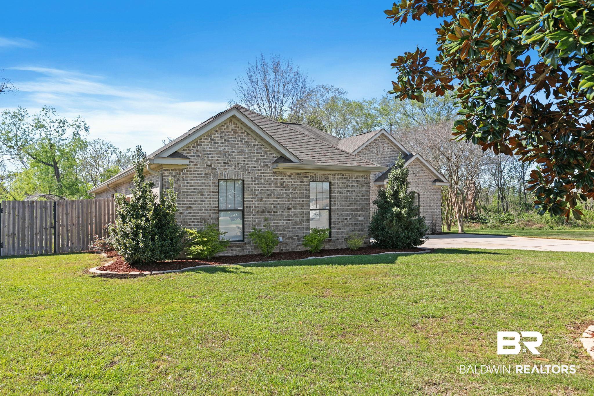 9584 Sanibel Loop Daphne, AL 36526 - Photo 5 of 48 View of front of home featuring brick siding and roof with shingles